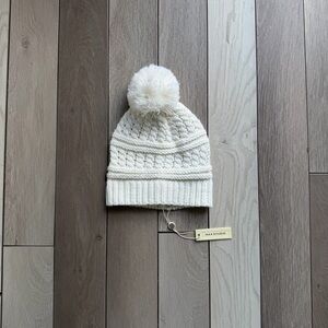 Max Studio ivory cable knit beanie with a pom-pom.